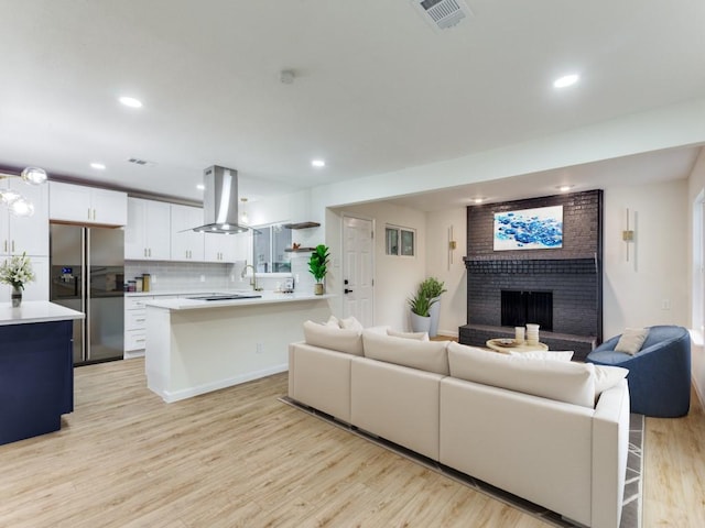 living room with a fireplace and light hardwood / wood-style flooring