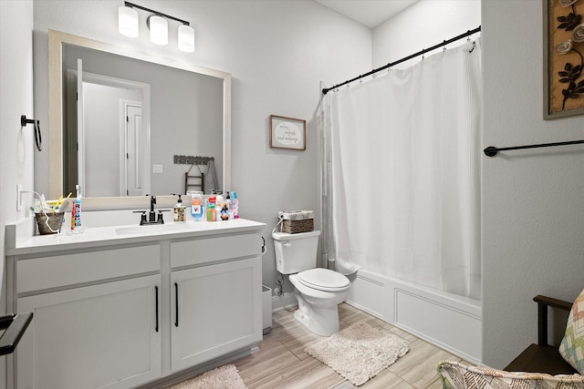 full bathroom with vanity, toilet, hardwood / wood-style floors, and shower / bath combo with shower curtain