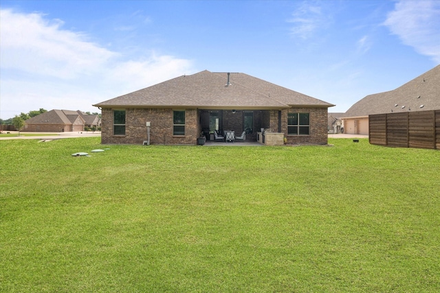 back of house featuring a yard and a patio area