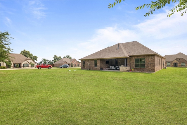 exterior space with a patio and a lawn