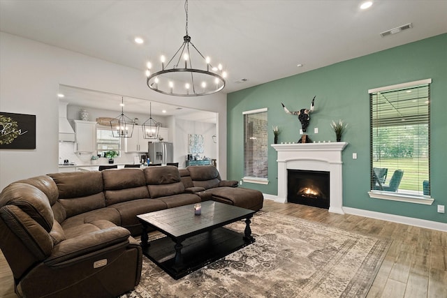 living room featuring light hardwood / wood-style flooring and a chandelier