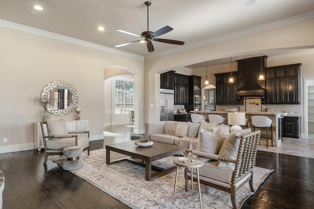 living room featuring crown molding, dark hardwood / wood-style floors, and ceiling fan