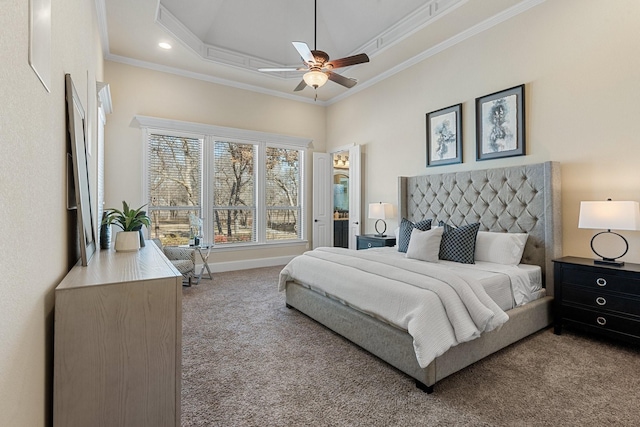 carpeted bedroom featuring crown molding, ceiling fan, and a raised ceiling