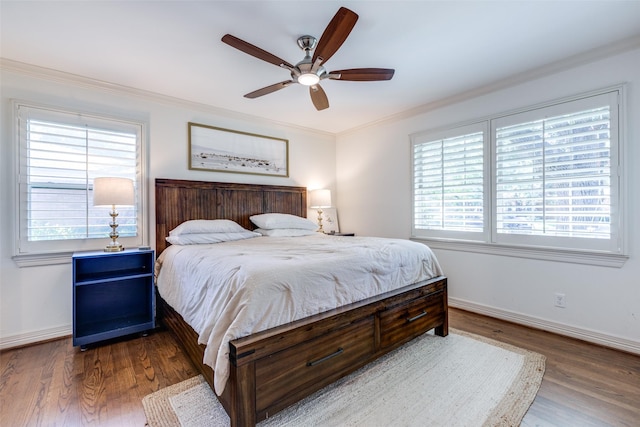 bedroom featuring hardwood / wood-style floors, ornamental molding, and ceiling fan