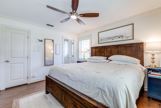 bedroom featuring crown molding, ceiling fan, and dark hardwood / wood-style floors