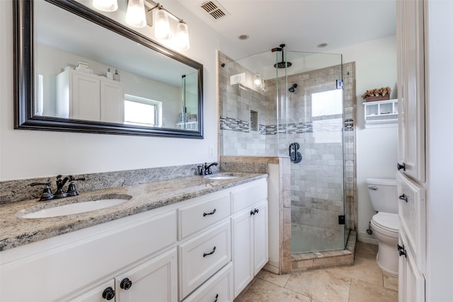 bathroom with vanity, toilet, and a shower with shower door