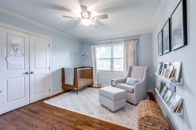 sitting room featuring crown molding, hardwood / wood-style flooring, and ceiling fan