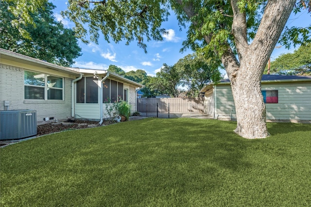 view of yard with cooling unit and a sunroom