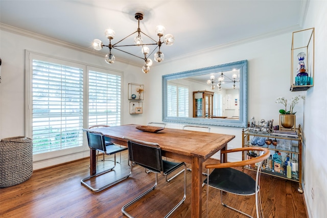 dining room featuring hardwood / wood-style flooring, ornamental molding, and a chandelier