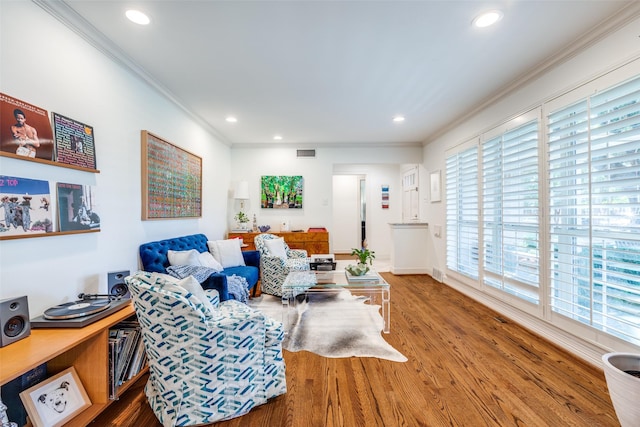 living room with hardwood / wood-style flooring and ornamental molding