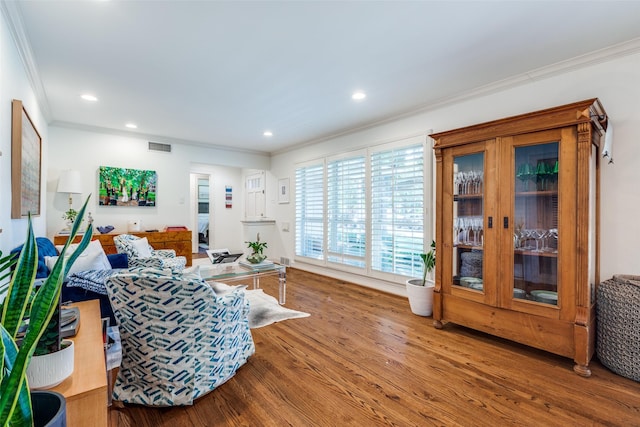 living room featuring crown molding and hardwood / wood-style flooring