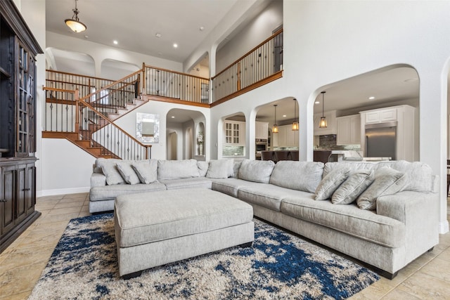 tiled living room with a towering ceiling