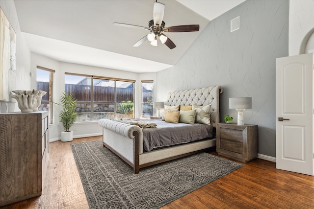 bedroom with lofted ceiling, dark wood-type flooring, and ceiling fan