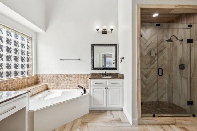 bathroom with vanity, parquet flooring, and independent shower and bath