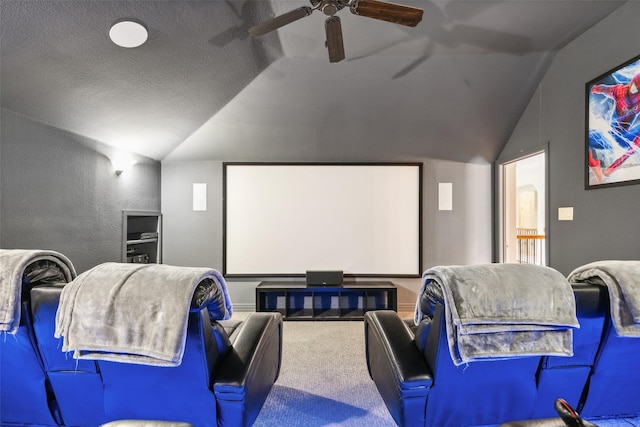 carpeted cinema with ceiling fan, vaulted ceiling, and a textured ceiling