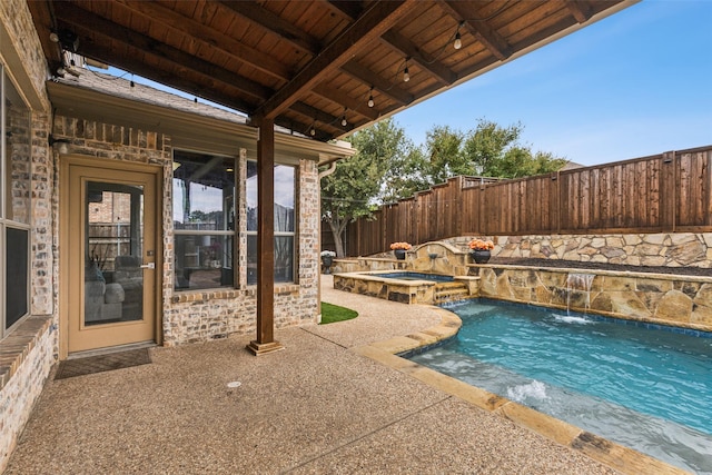 view of swimming pool with an in ground hot tub, pool water feature, and a patio area