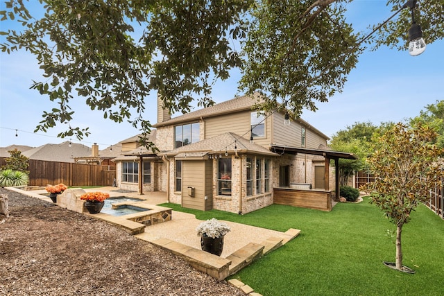 back of property featuring an outdoor fire pit, a yard, and a patio area