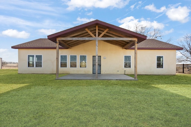 rear view of house with a lawn and a patio area