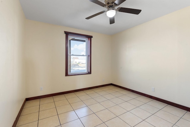 empty room featuring light tile patterned flooring and ceiling fan