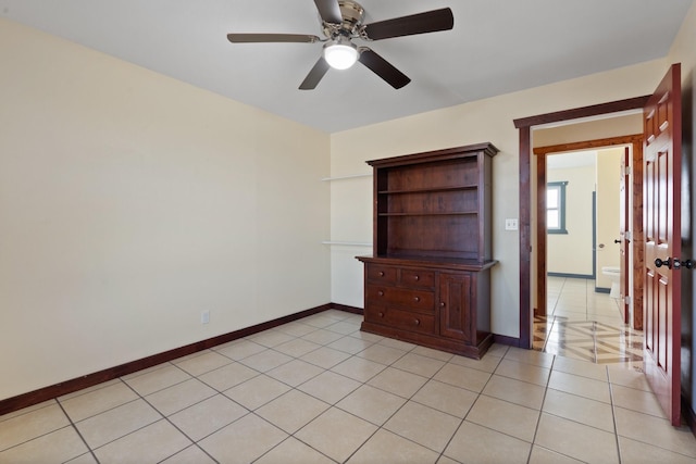 spare room featuring light tile patterned flooring and ceiling fan