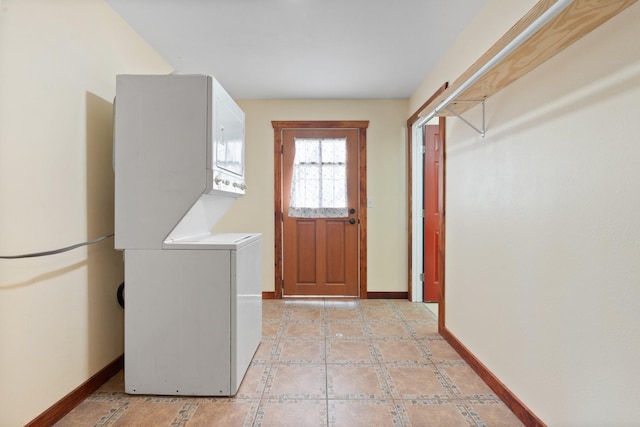 clothes washing area featuring stacked washer and clothes dryer