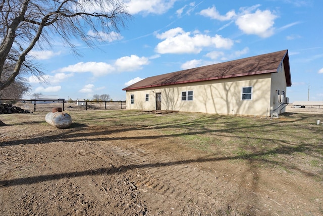 rear view of house with an outbuilding and a lawn