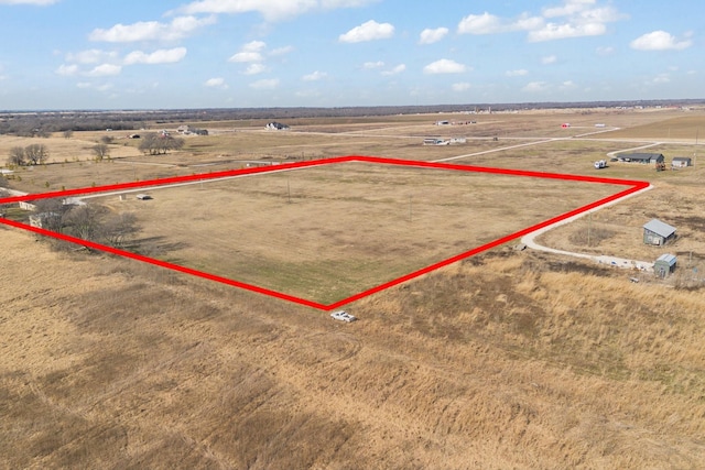 birds eye view of property with a rural view