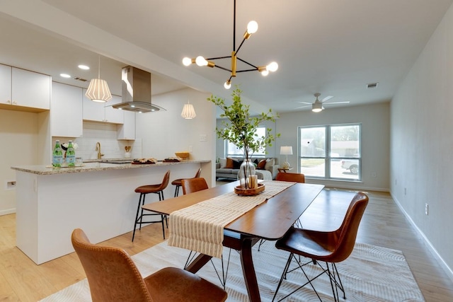 dining area featuring light hardwood / wood-style flooring and ceiling fan