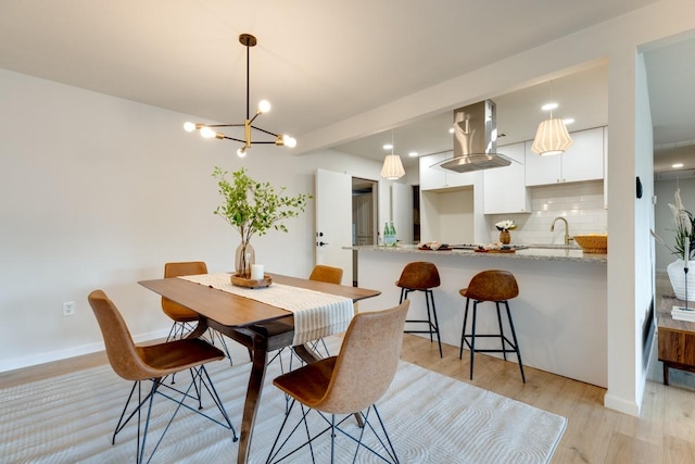 dining area featuring sink and light hardwood / wood-style flooring