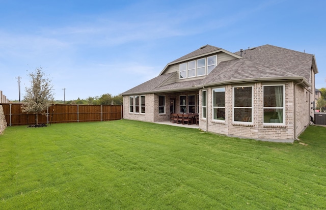 back of property featuring a lawn and a patio