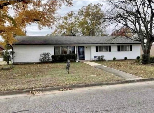 ranch-style home with a front lawn