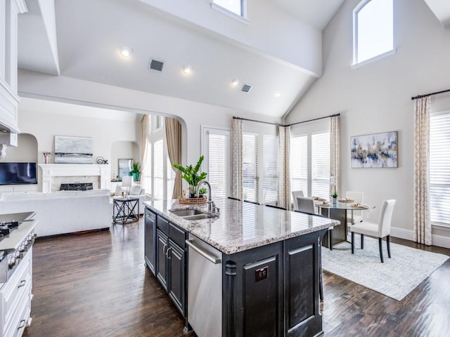 kitchen with sink, dishwasher, a kitchen island with sink, white cabinets, and dark hardwood / wood-style flooring