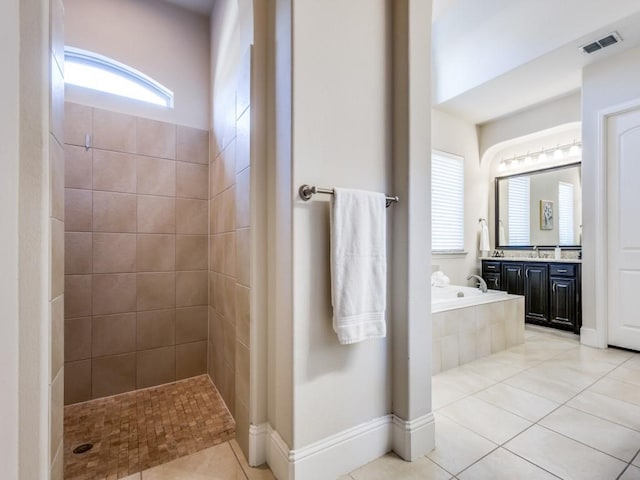 bathroom with plus walk in shower, tile patterned floors, and vanity