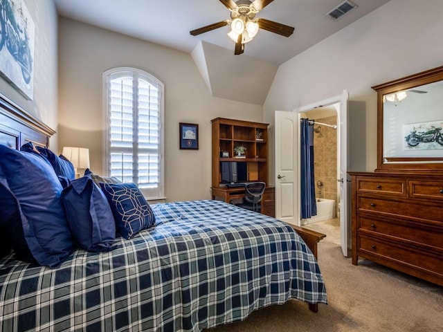 bedroom with multiple windows, ceiling fan, light carpet, and ensuite bath