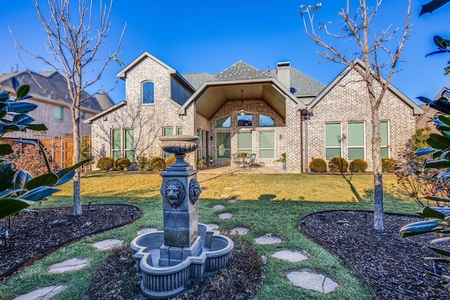 front of property with a patio and a front yard