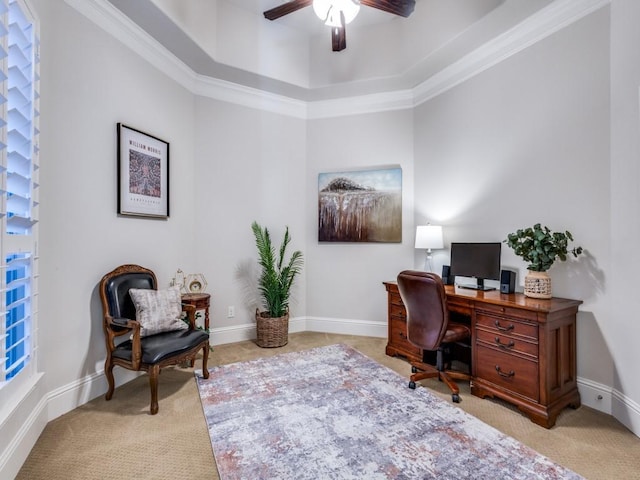 office area with ornamental molding, light colored carpet, ceiling fan, and a tray ceiling