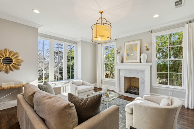 living room featuring crown molding, a fireplace, and dark wood-type flooring