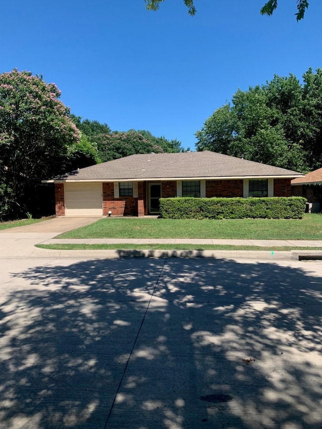 5014 Brookhollow Dr, Sachse, TX 75048 - view of front of home featuring a garage, driveway, a front yard, and brick siding