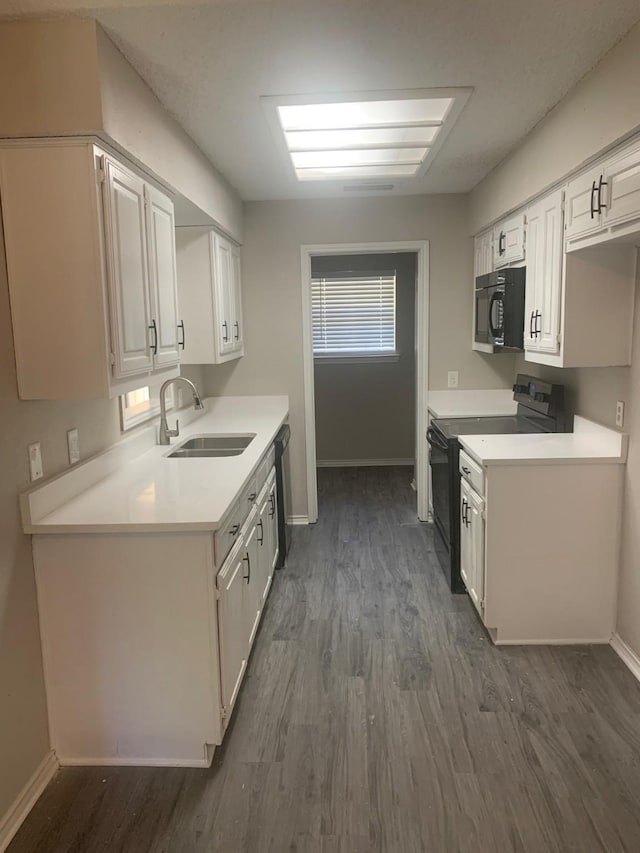 5014 Brookhollow Dr, Sachse, TX 75048 - kitchen with black appliances, a sink, dark wood-style flooring, baseboards, and light countertops