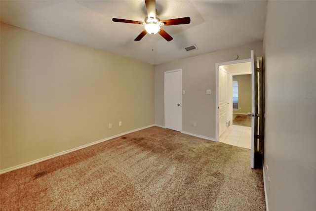 unfurnished bedroom with ceiling fan and light carpet