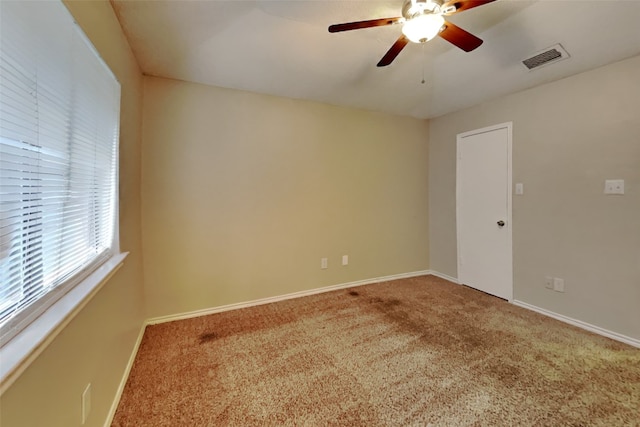 carpeted empty room featuring ceiling fan