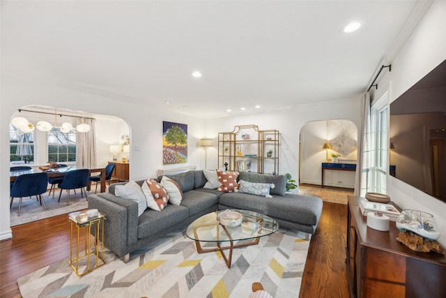 living room featuring hardwood / wood-style floors and crown molding