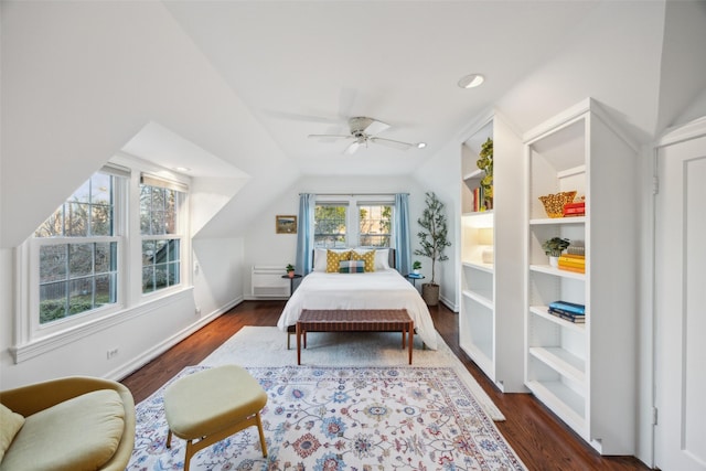 bedroom featuring dark wood-type flooring, vaulted ceiling, and ceiling fan