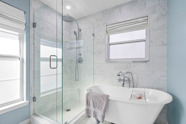 bathroom featuring shower with separate bathtub