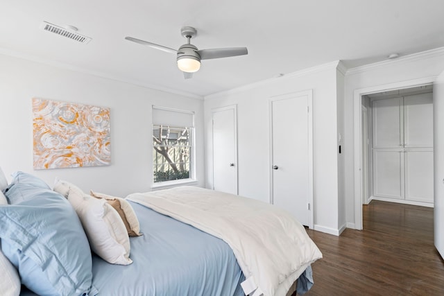 bedroom featuring dark hardwood / wood-style flooring, crown molding, and ceiling fan