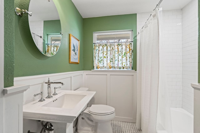 full bathroom with sink, toilet, and shower / bath combo with shower curtain