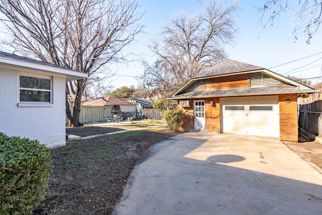 exterior space with a garage and an outdoor structure