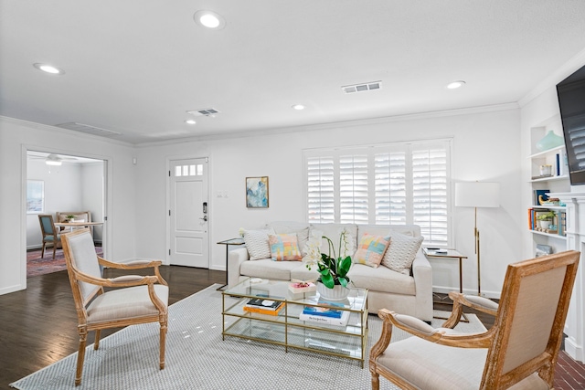 living room with ornamental molding and dark wood-type flooring