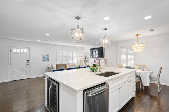 kitchen featuring sink, a center island with sink, dishwasher, pendant lighting, and white cabinets