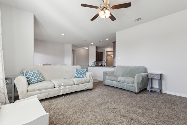 carpeted living room featuring ceiling fan